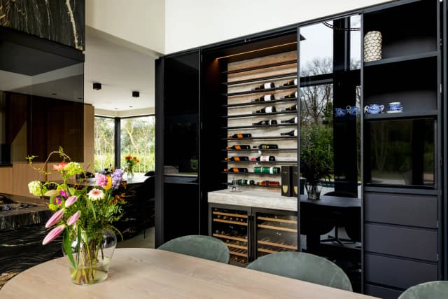 steel glazed wine cabinet in a kitchen