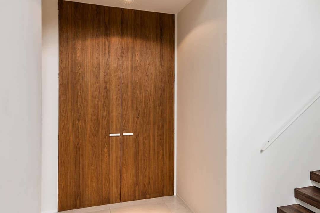 timber double flush doors in an entrance hall with wooden steps