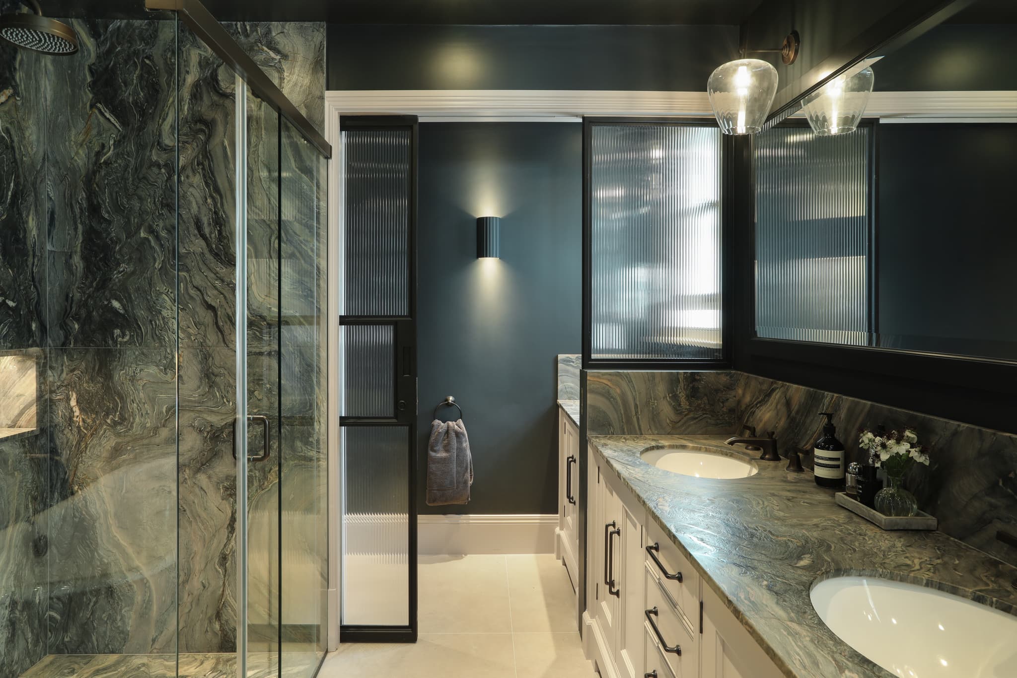 sliding steel glazed doors for a shower room creating a division in a larger bathroom