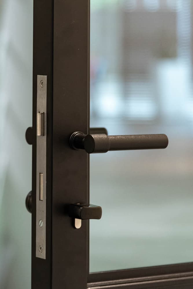 Piet - G5XL Handle - a lever handle for a steel-glazed door in a black powder coat finish