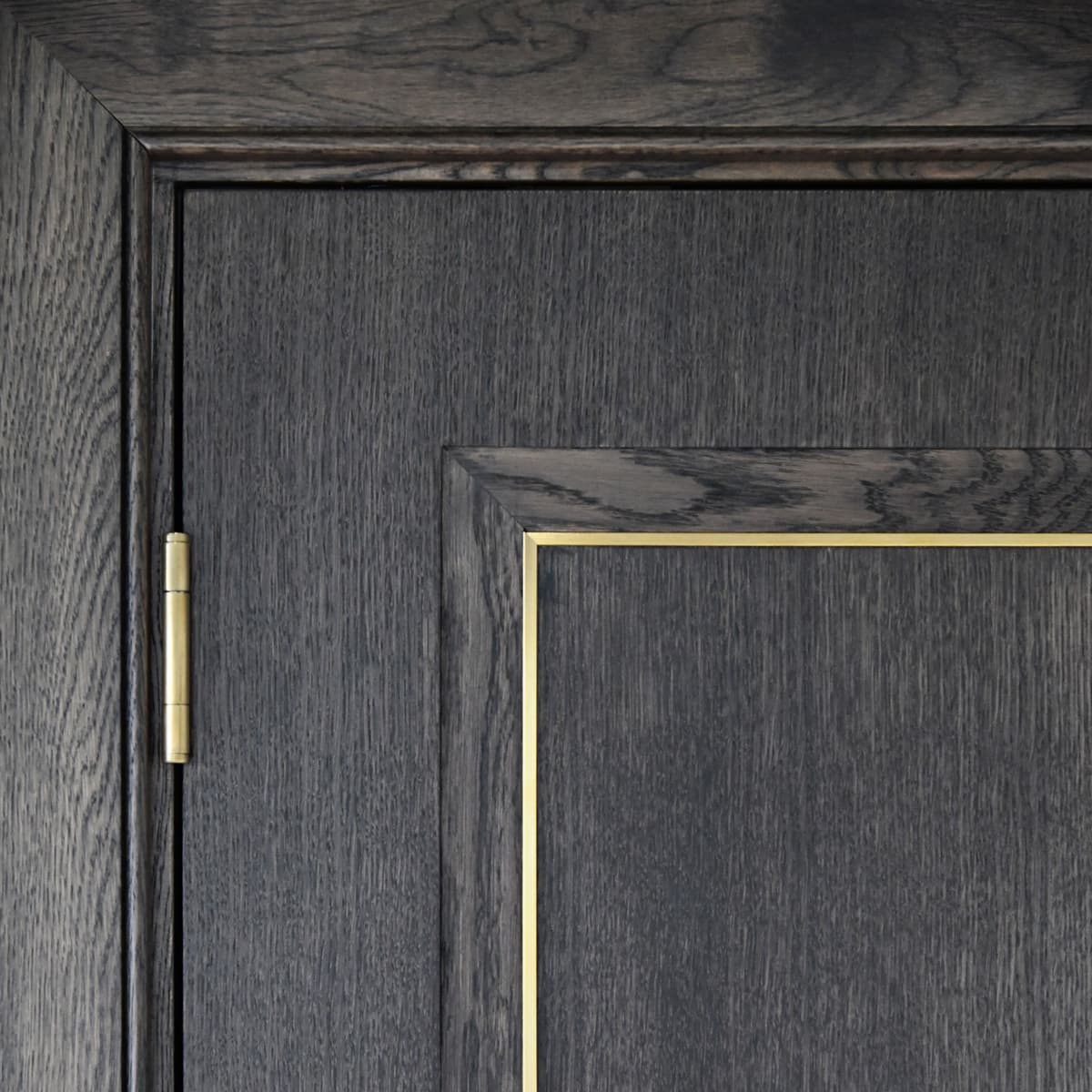 a timber door with metal inlay in brass and glazing